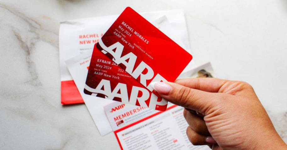 hands holding red aarp cards