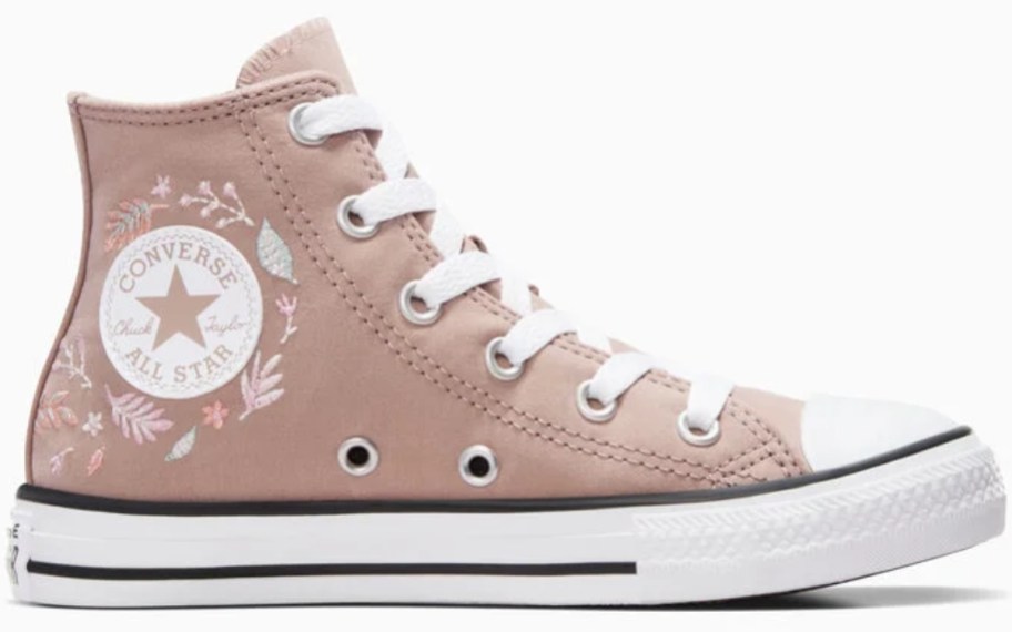 a kid's Converse high top shoe in pink with leaves embroidered on it