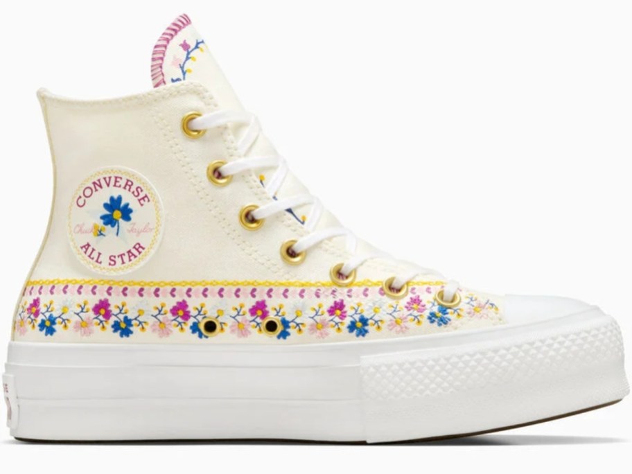 a women's Chuck Taylor Converse shoe in off white with embroidered flower details