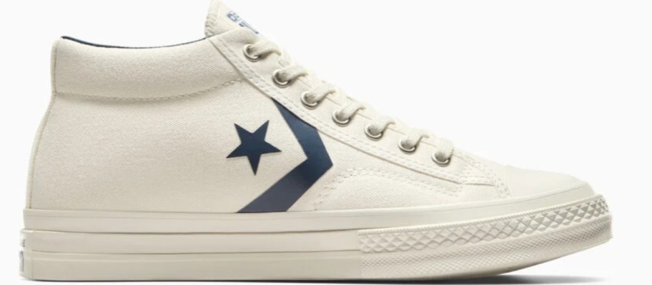 a Converse sneaker in off white with blue accents