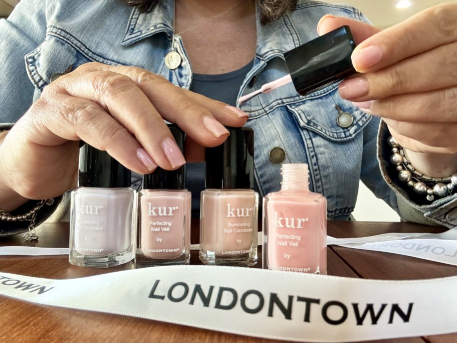 woman painting her nails with Londontown nail polish