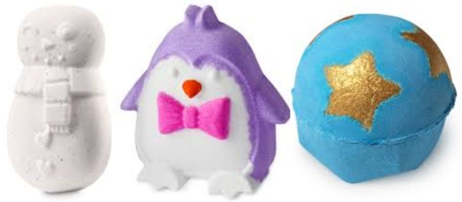 3 bath bombs, one white that looks like a Snowman, one purple and white penguin, and one a blue round one with gold stars