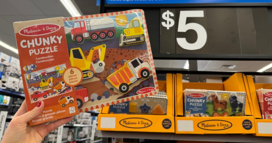 person holding up Melissa & Doug Wooden Puzzle at Walmart next to $5 signage