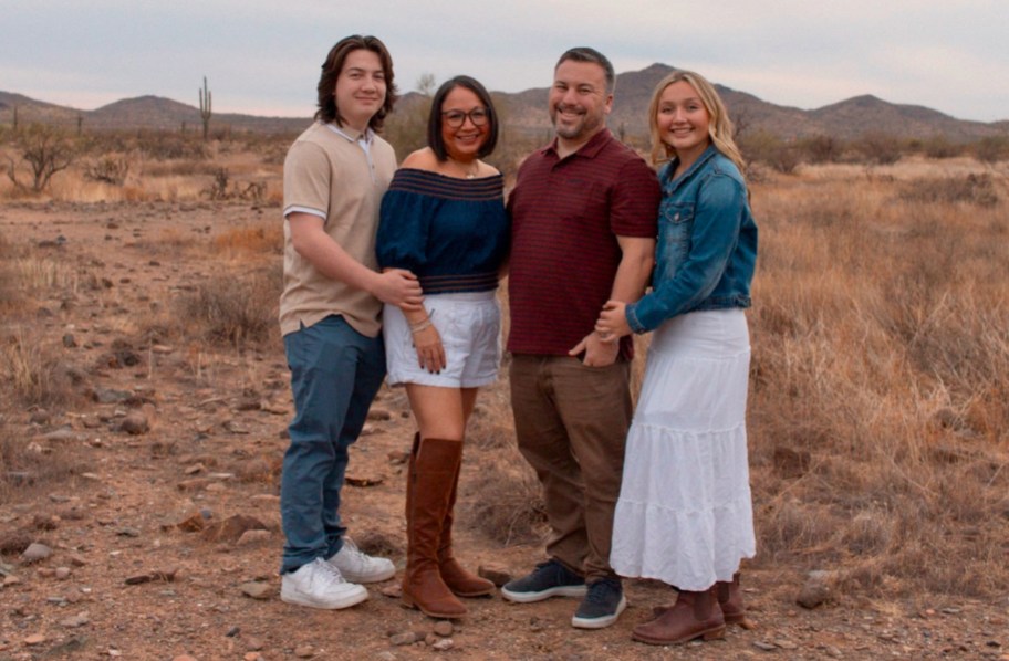 Coordinating family with two teenage kids standing in desert