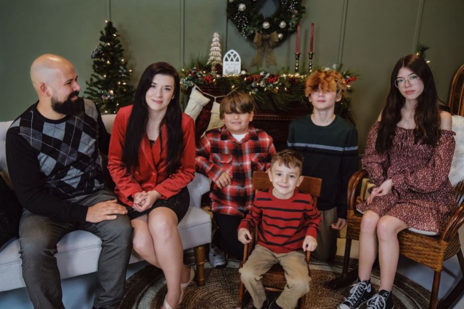 christmas family sitting in decorated holiday room