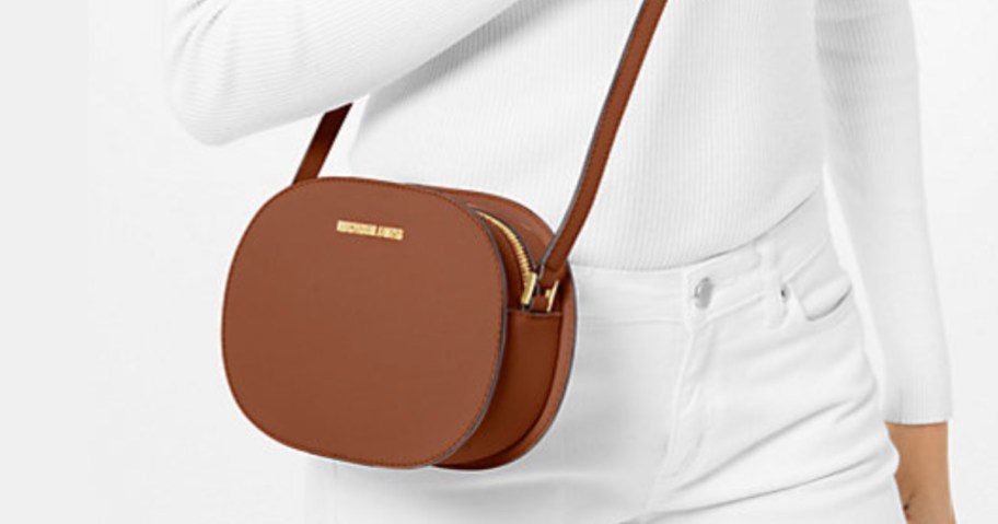 woman in a white outfit with a brown crossbody bag