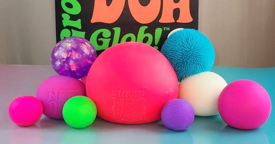 assortment of squish balls in various sizes and colors on table