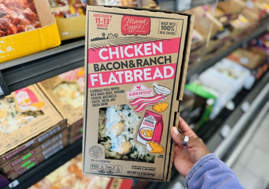 a womans hand holding a package of chicken bacon ranch flatbreads