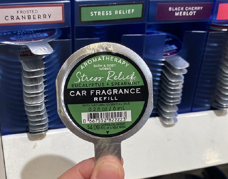 person holding a bath & body works car fragrance refill