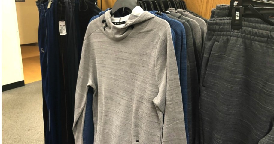 men's hoodie hanging in Kohl's next to a pair of matching pants