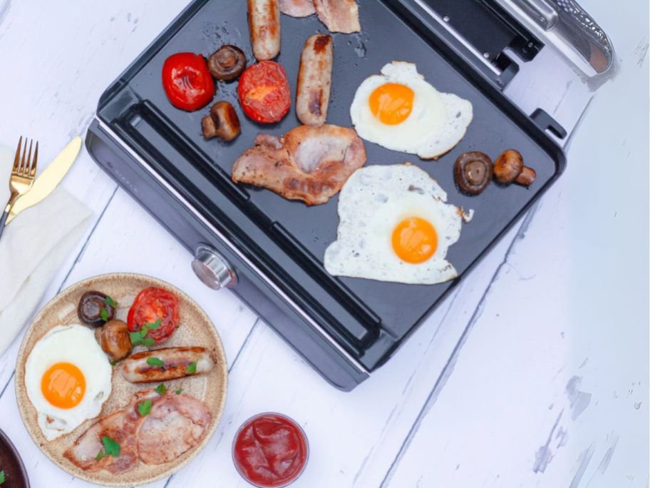 Ninja Sizzle 14" Electric Griddle with food around it