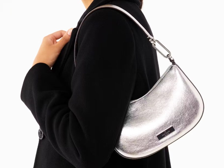 woman in a black jacket with a metallic silver shoulder bag