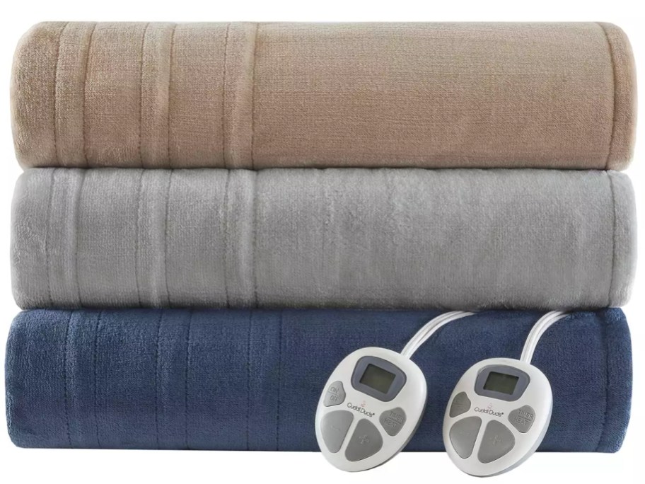 stack of 3 solid color heated blankets folded, colors are tan, grey and blue