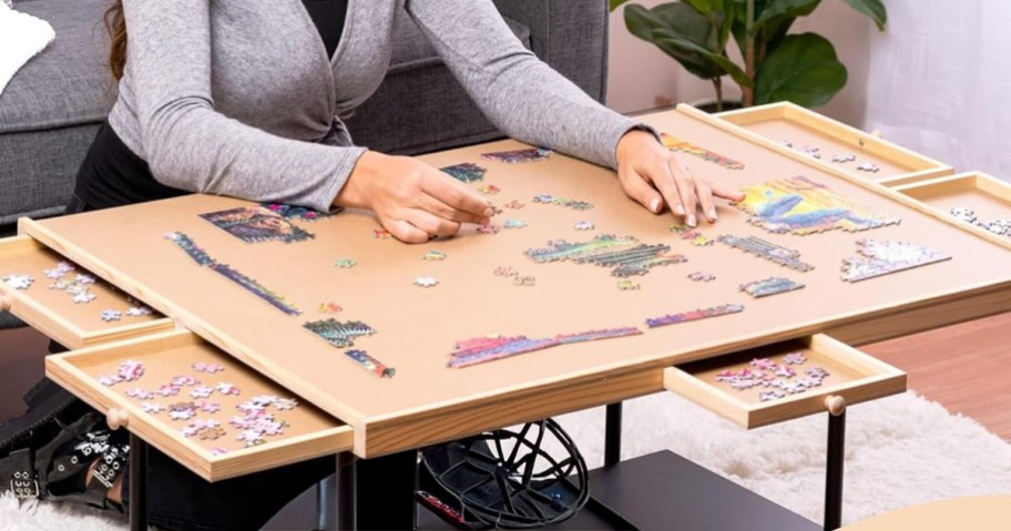 woman putting together a puzzle on a table