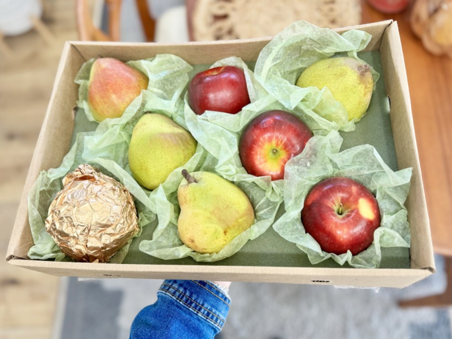 hand under a box of Harry & David Pears & Apples