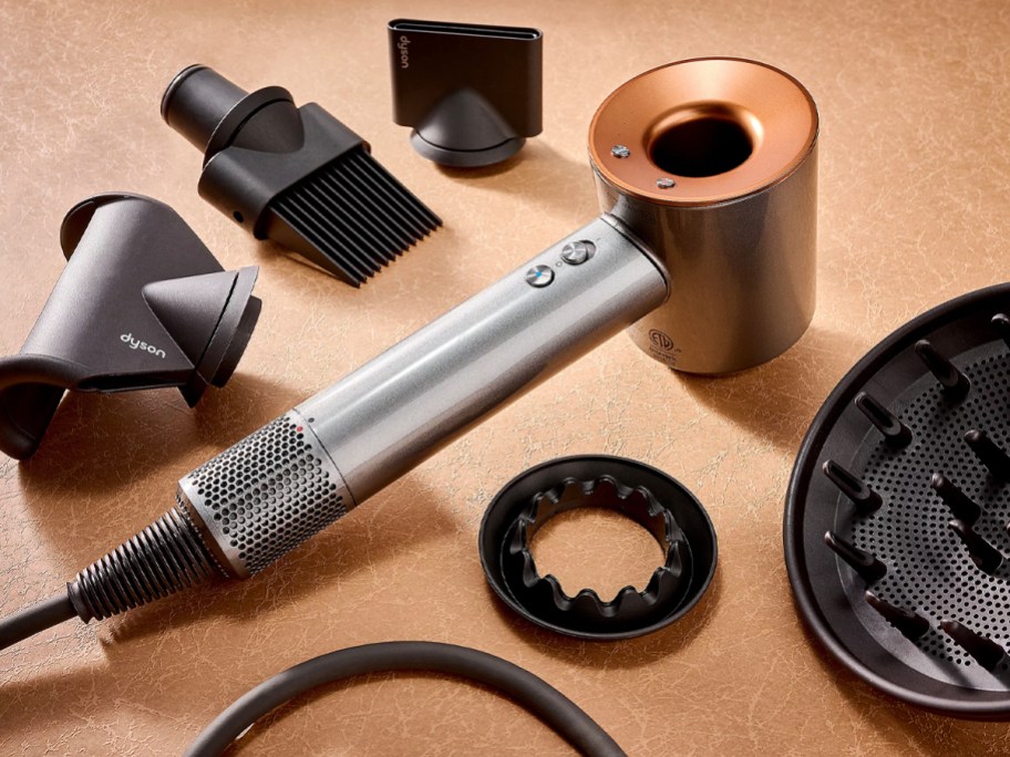 dyson supersonic hair dryer on table with attachments