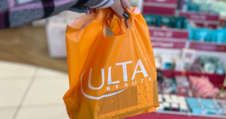 hand holding ulta shopping bag in store