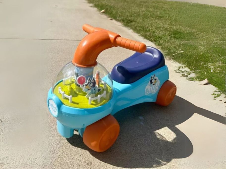 Bluey Keepy Uppy Interactive Play Ride-On on sidewalk