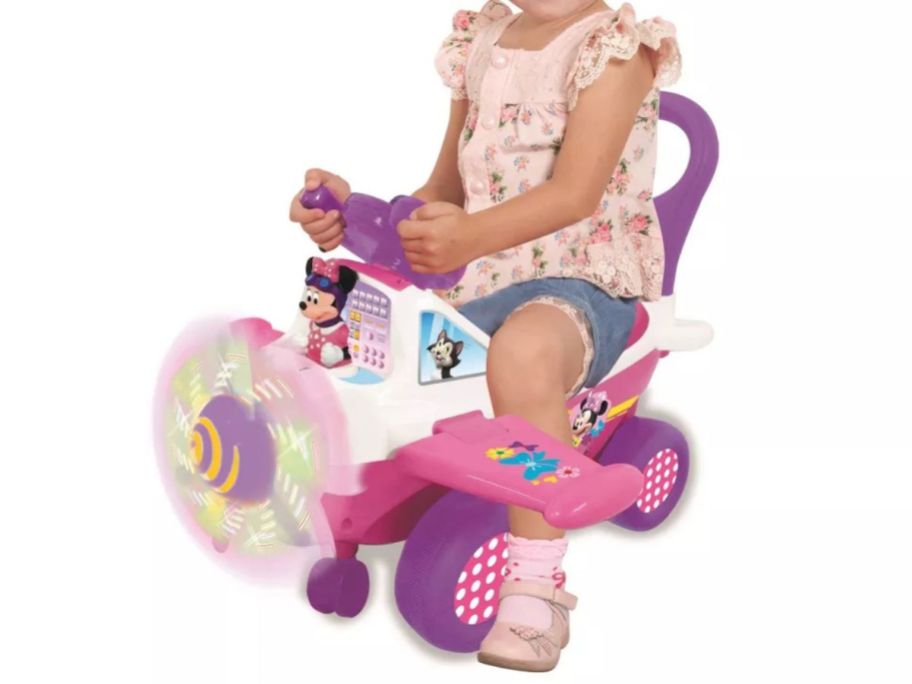 kid sitting on Disney Kiddieland Minnie Activity Plane Ride-On