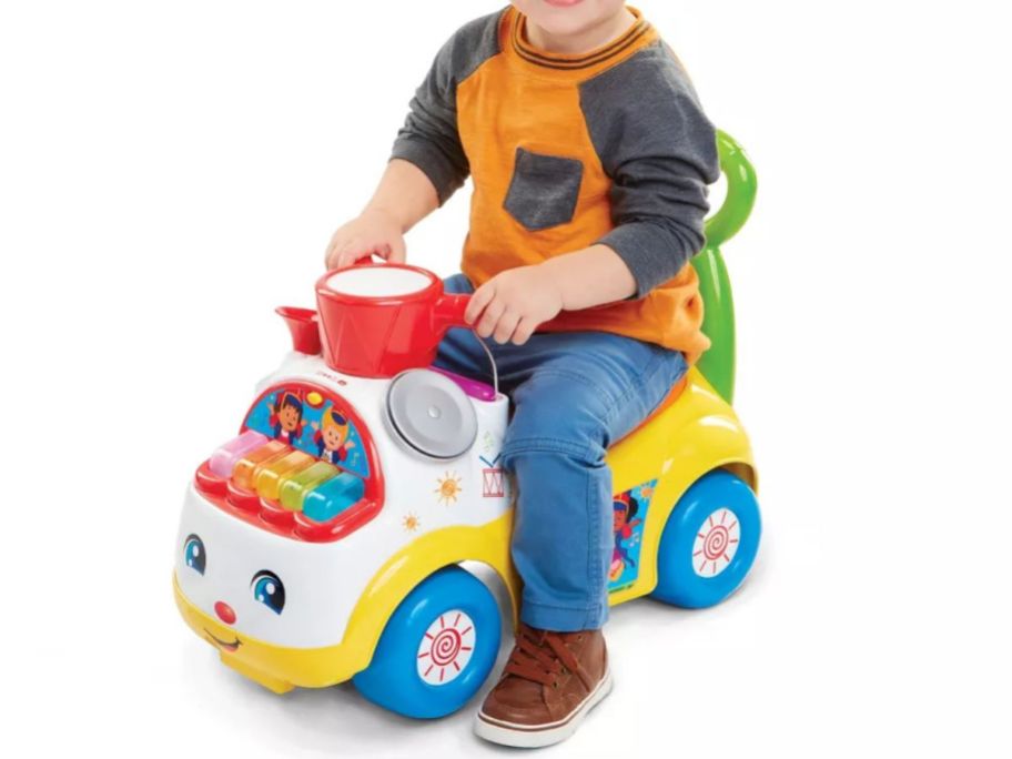 kid on Fisher-Price Little People Music Parade Ride-On