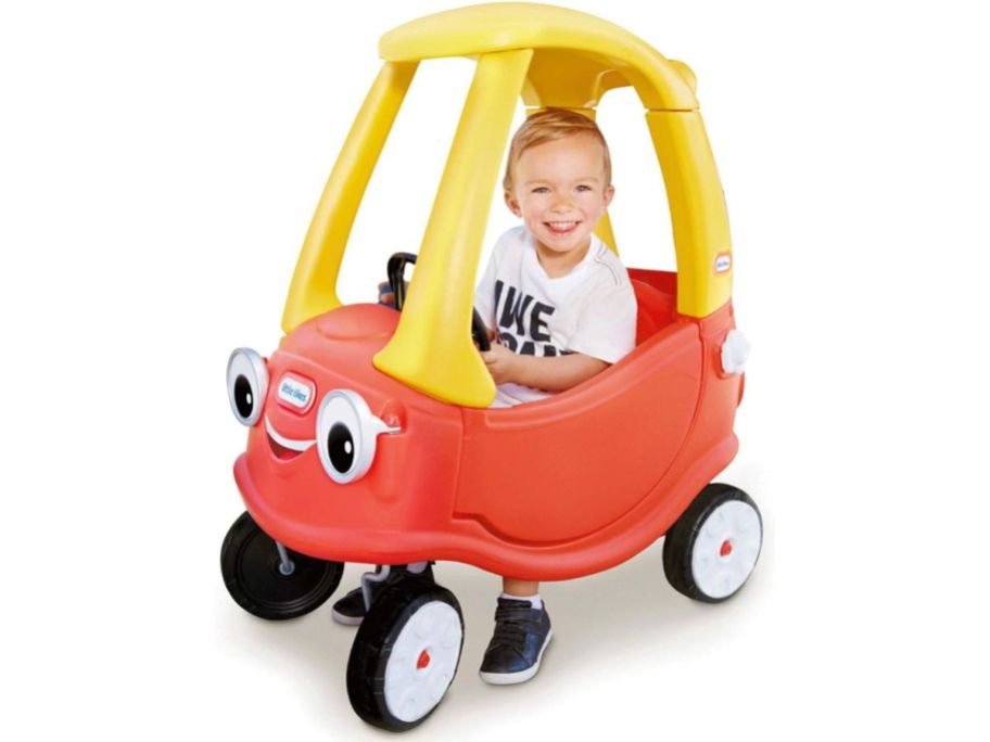 Little boy in a Little Tikes Cozy Coupe