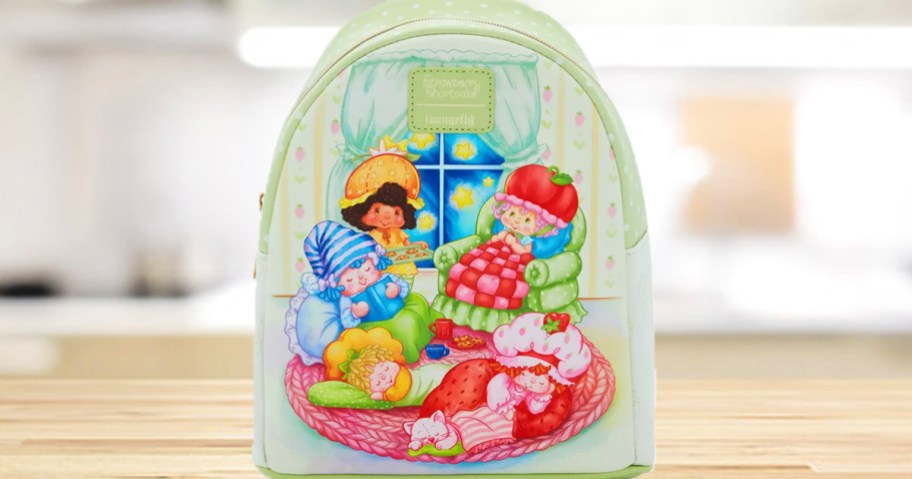 green strawberry shortcake backpack on countertop 