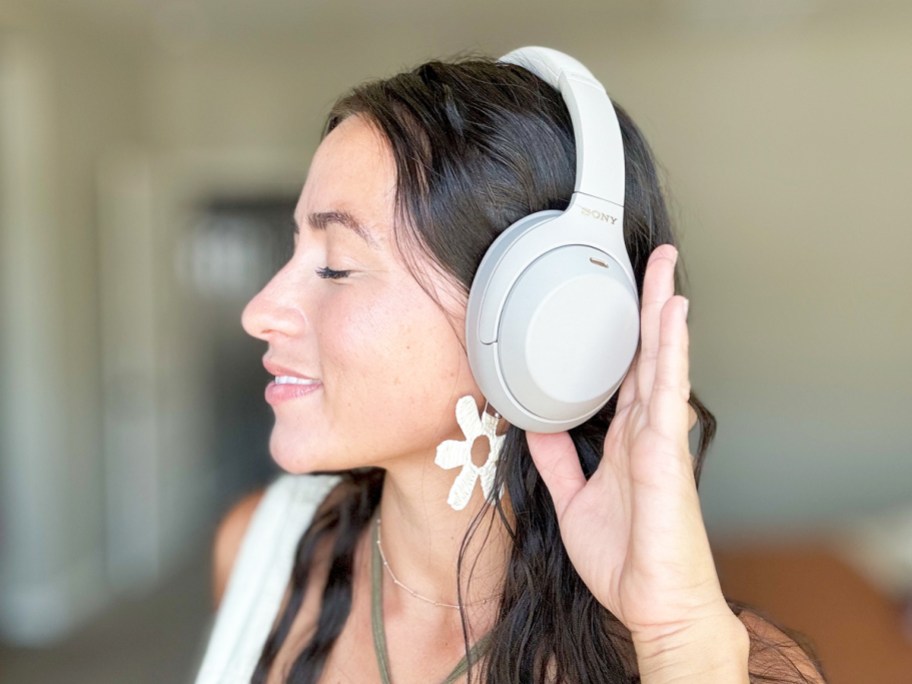 woman wearing a pair of white sony headphones