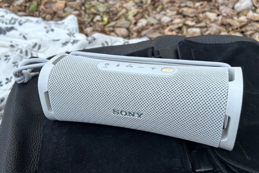 white sony speaker on backpack