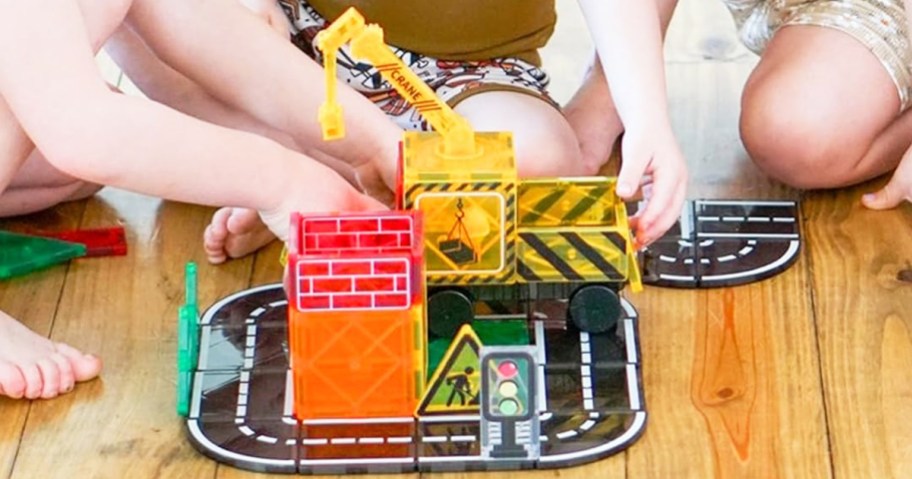 kids playing with road themed magnetic tiles set