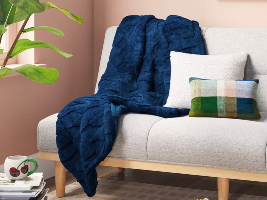 dark blue throw blanket draped over couch