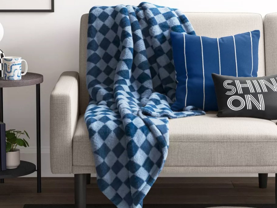 blue checkered throw blanket draped over couch