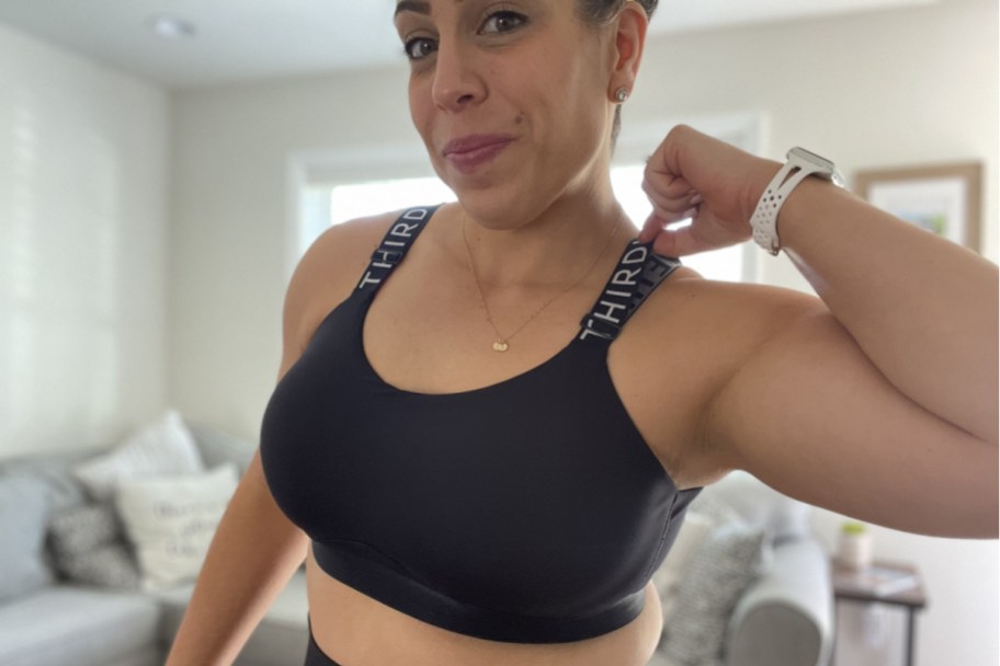 woman holding sports bra strap