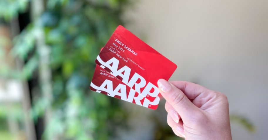 hands holding red aarp cards