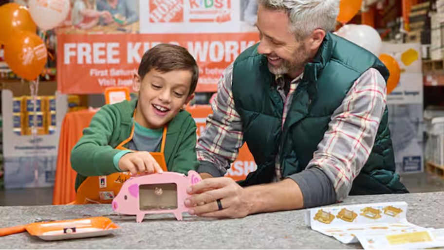 father and son building piggy bank at home depot kids workshop