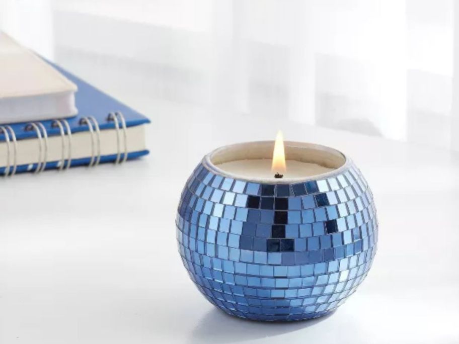 A lit Threshold Disco Ball Candle 