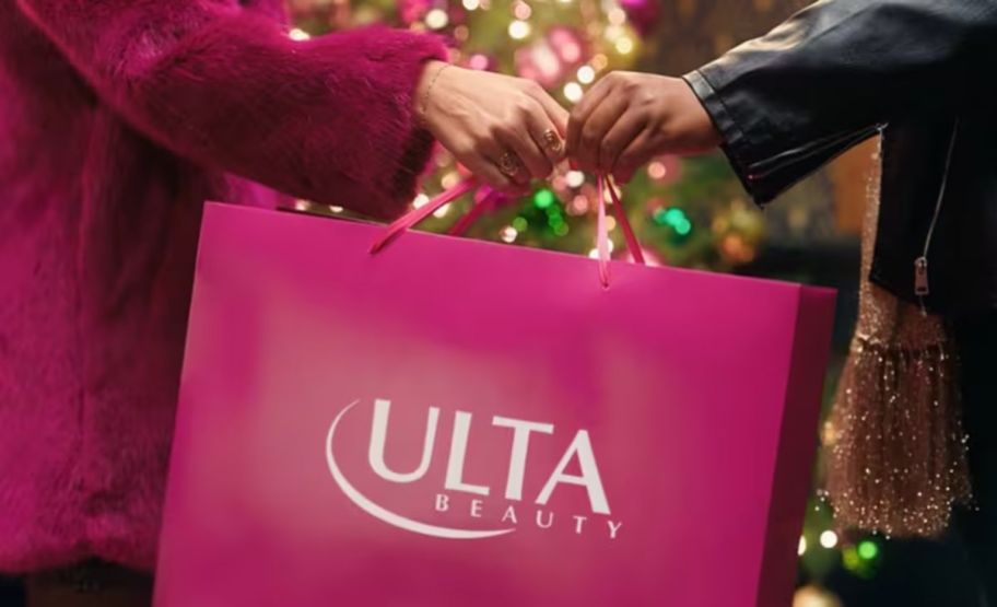 two women passing an ulta shopping bag