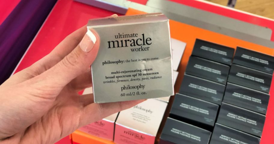 woman hand holding ultimate miracle worker box