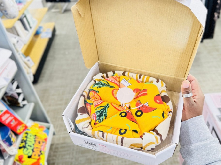 hand holding pizza box with socks 