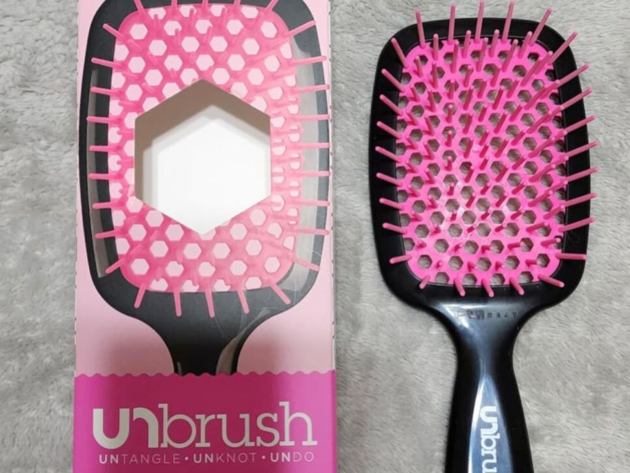 A pink and Black UNbrush