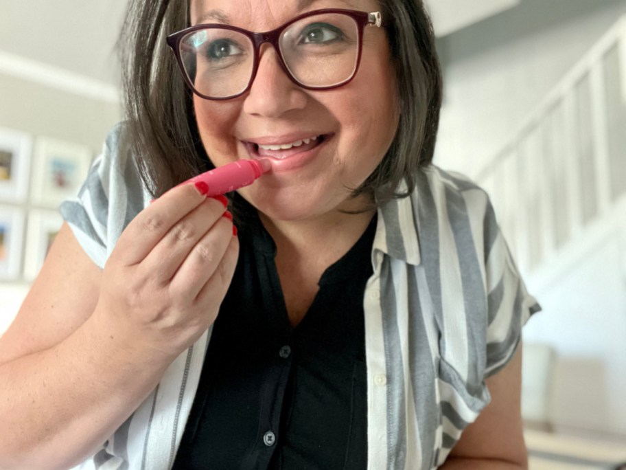 woman applying laneige lip glowy balm