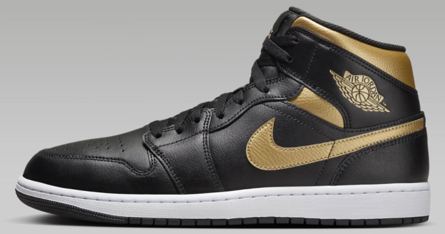 a Nike Air Jordan mid top men's shoe in black with gold and white accents