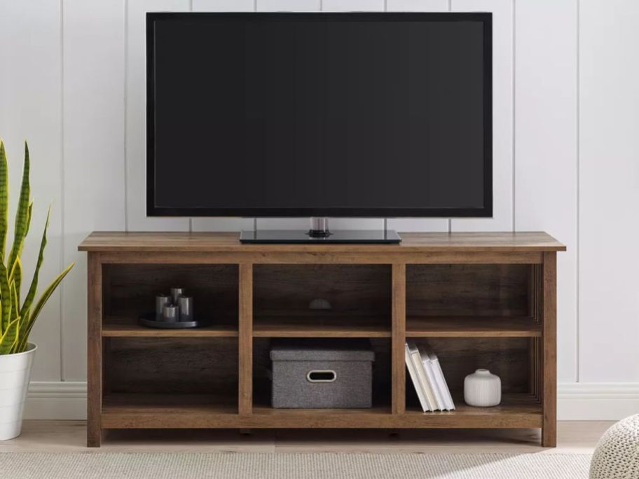 Saracina Home Mission Slatted Media Console TV Stand with tv on it