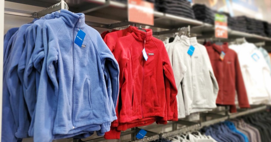 columbia fleece jackets in a row on store display wall