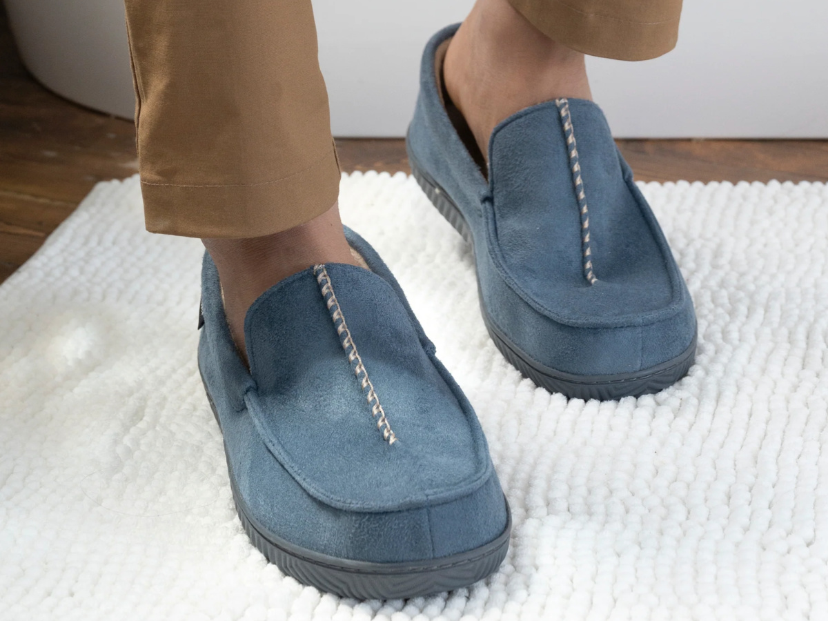 man wearing blue Isotoner Men's Advanced Memory Foam Microsuede Liam Moccasin Slippers