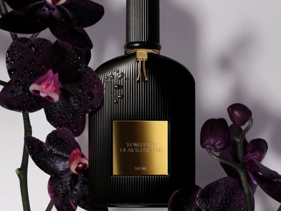 a bottle of Tom Ford Black Orchid with black orchids around it