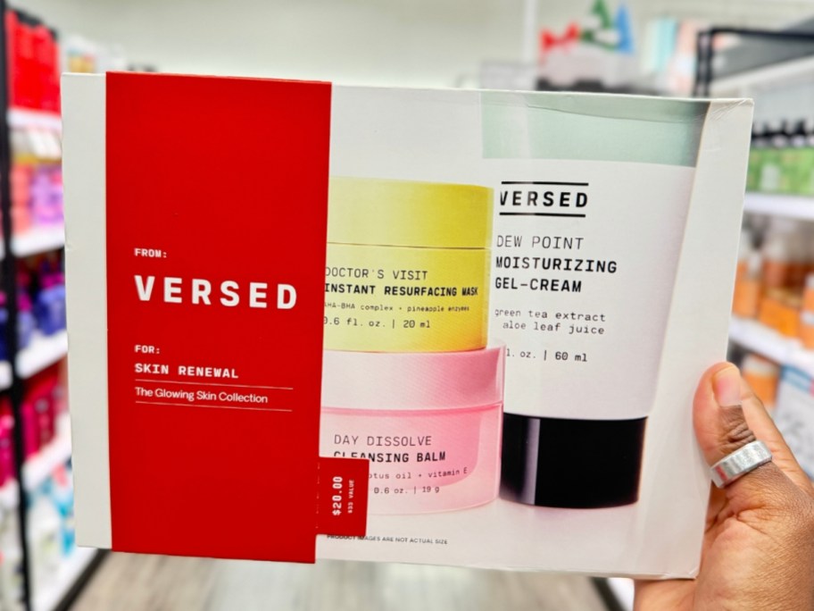 hand holding a Versed skincare gift set in a box 