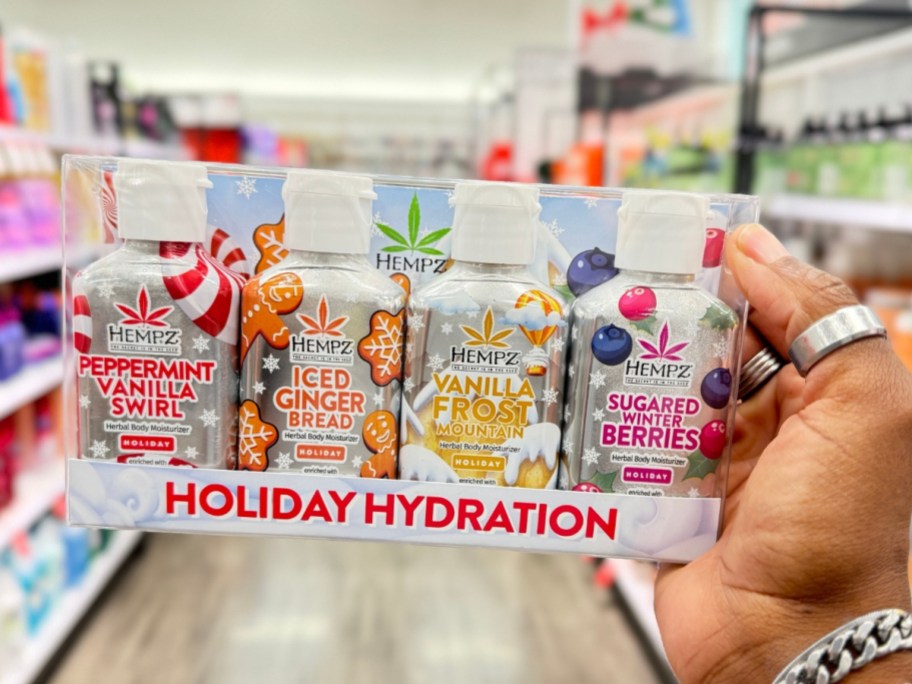 hand holding a Hempz Mini Body Lotion - Holiday Hydraton Gift Set with 4 small Hempz lotions in it