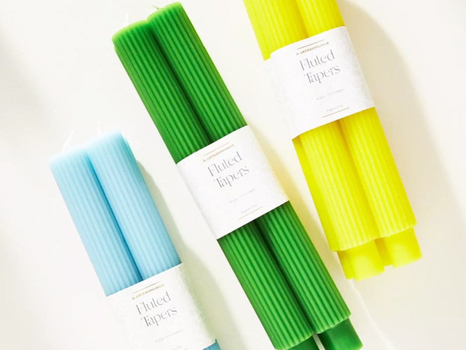 blue, green, and yellow sets of taper candles