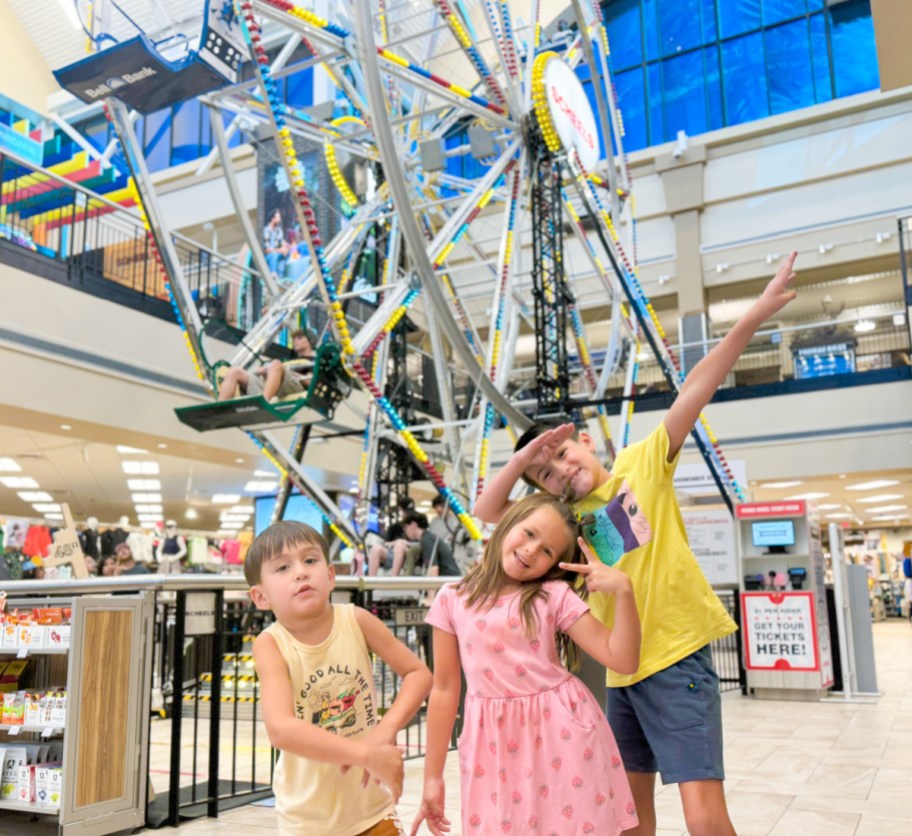 kids standing in front of ferris wheel