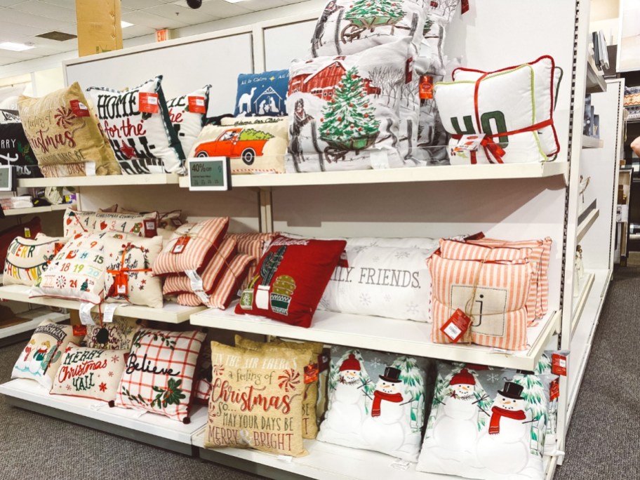 an aisle in Kohl's with Christmas pillows on the shelves